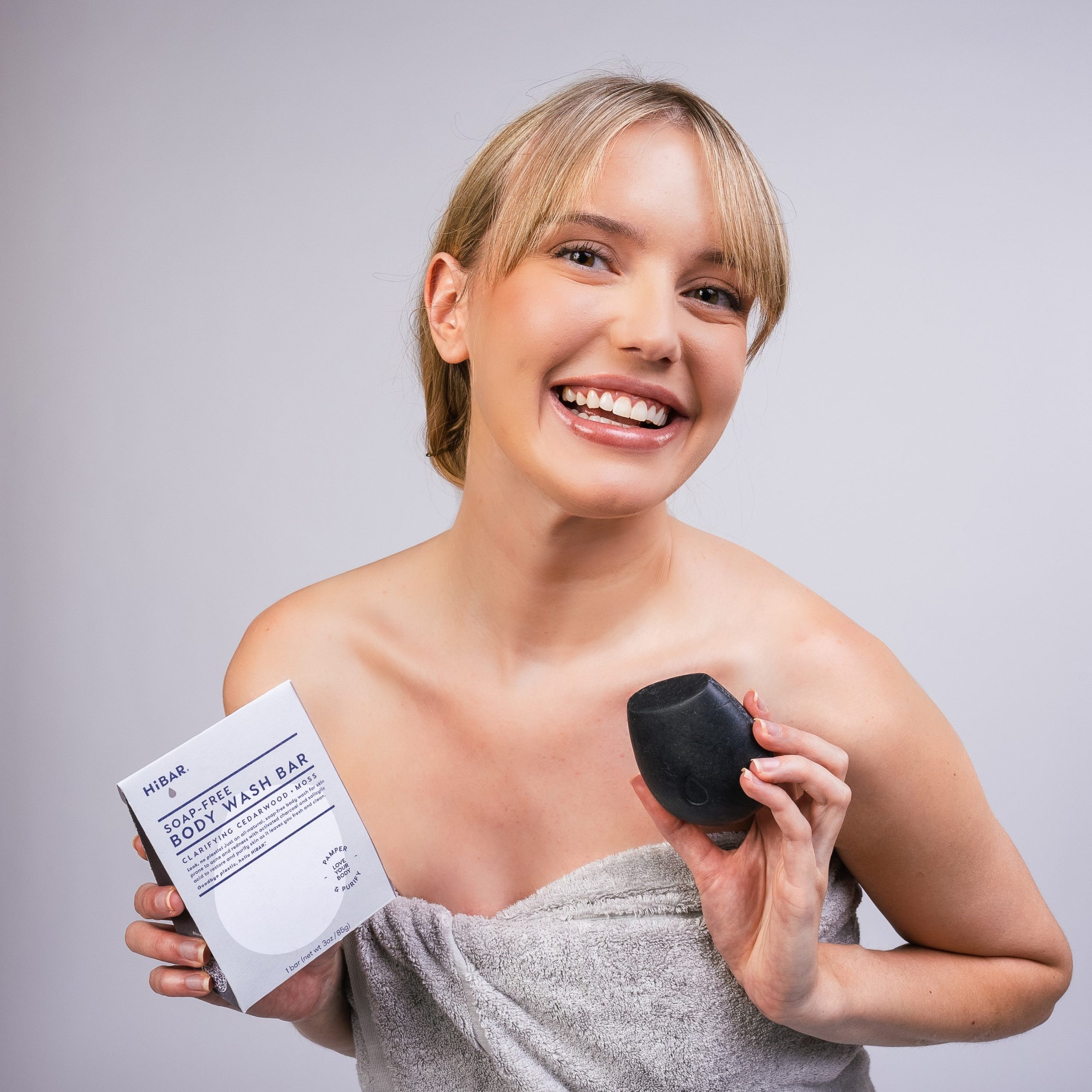 BodyWash_Clarify_Model_blonde_holdingbar_packaging.jpg