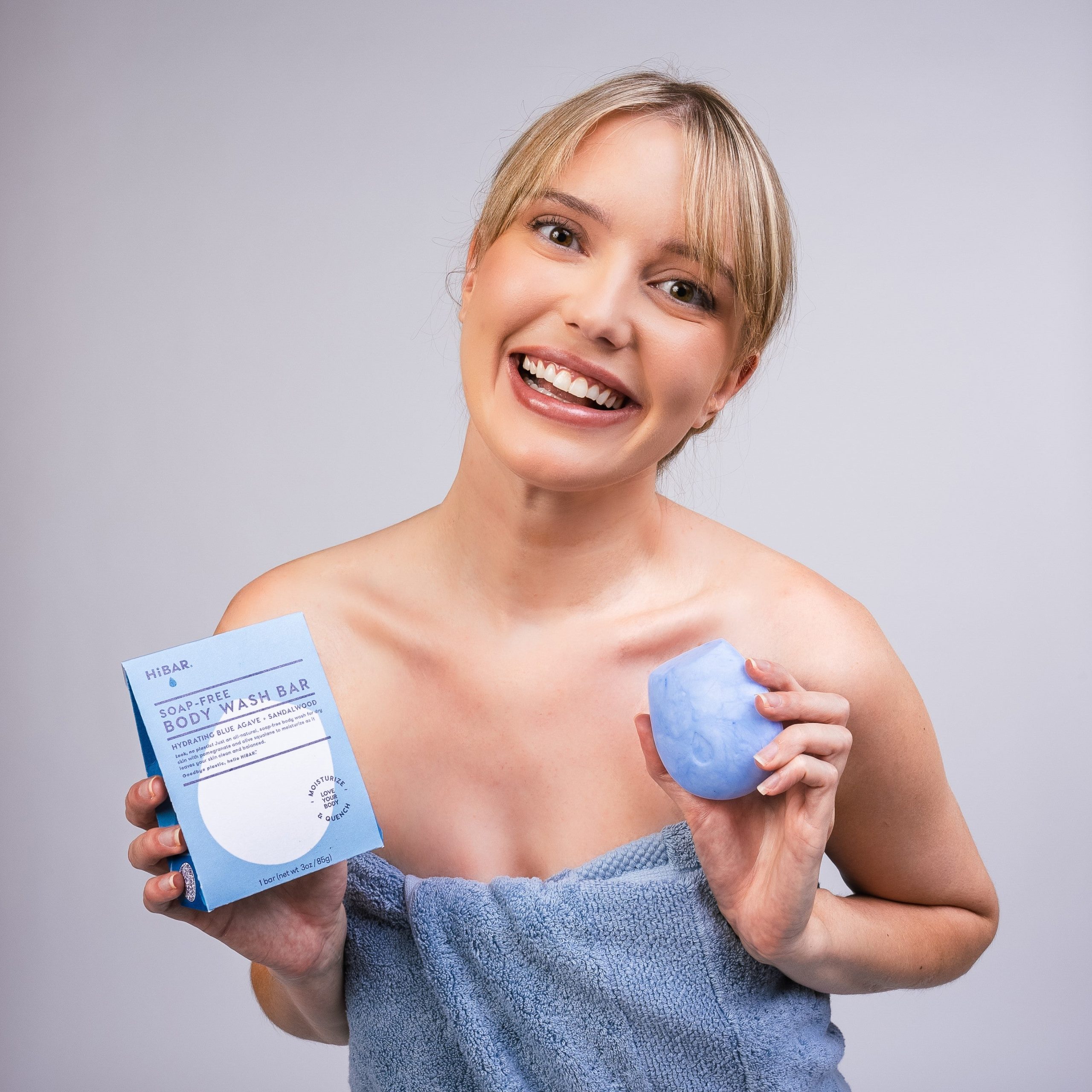 BodyWash_Hydrate_Modelholdingbar_packaging_blondemodel.jpg