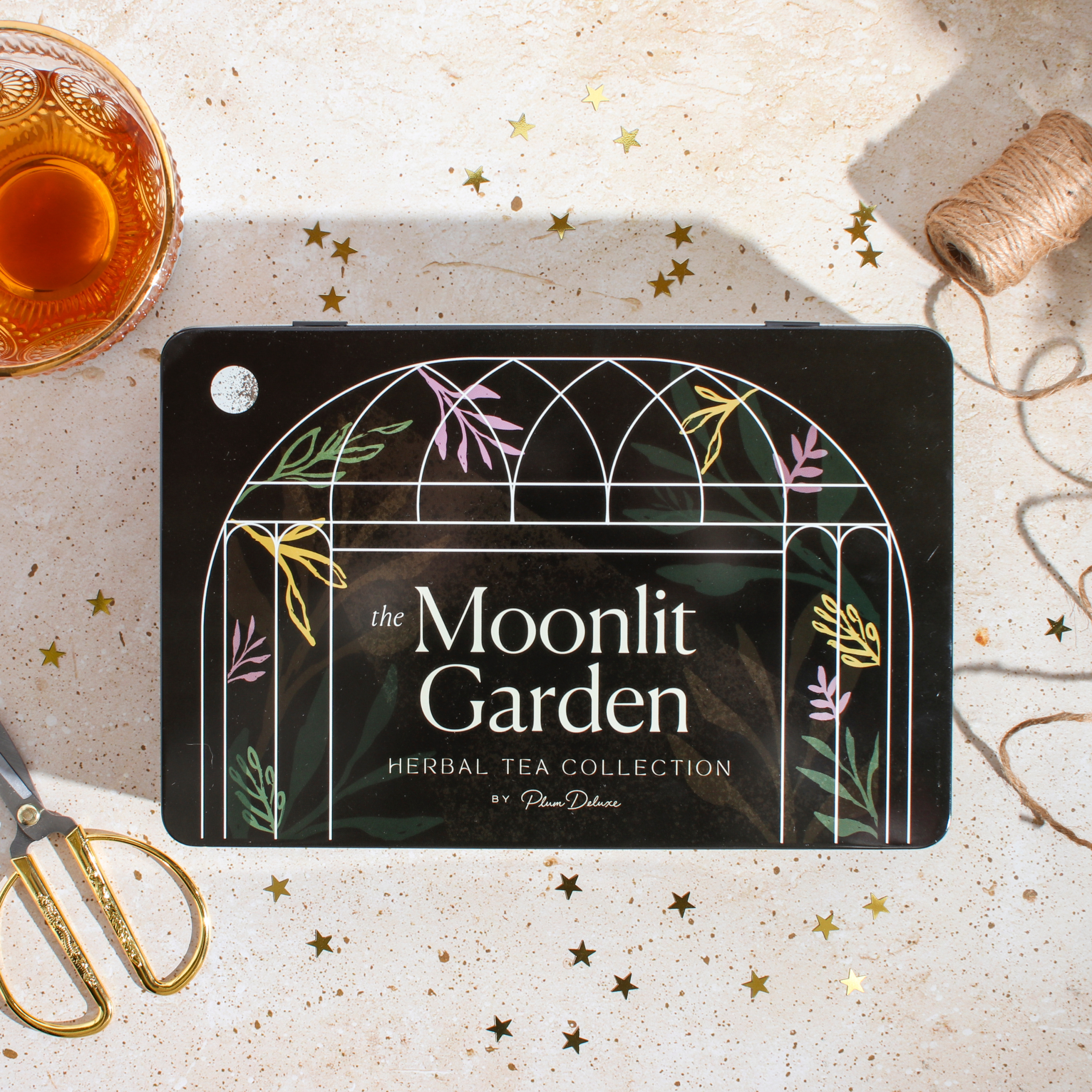 PlumDeluxe_TeaGiftTin_MoonlitGarden_Lifestyle_974e01d7-db52-4561-a26e-390c3c0d138d.png