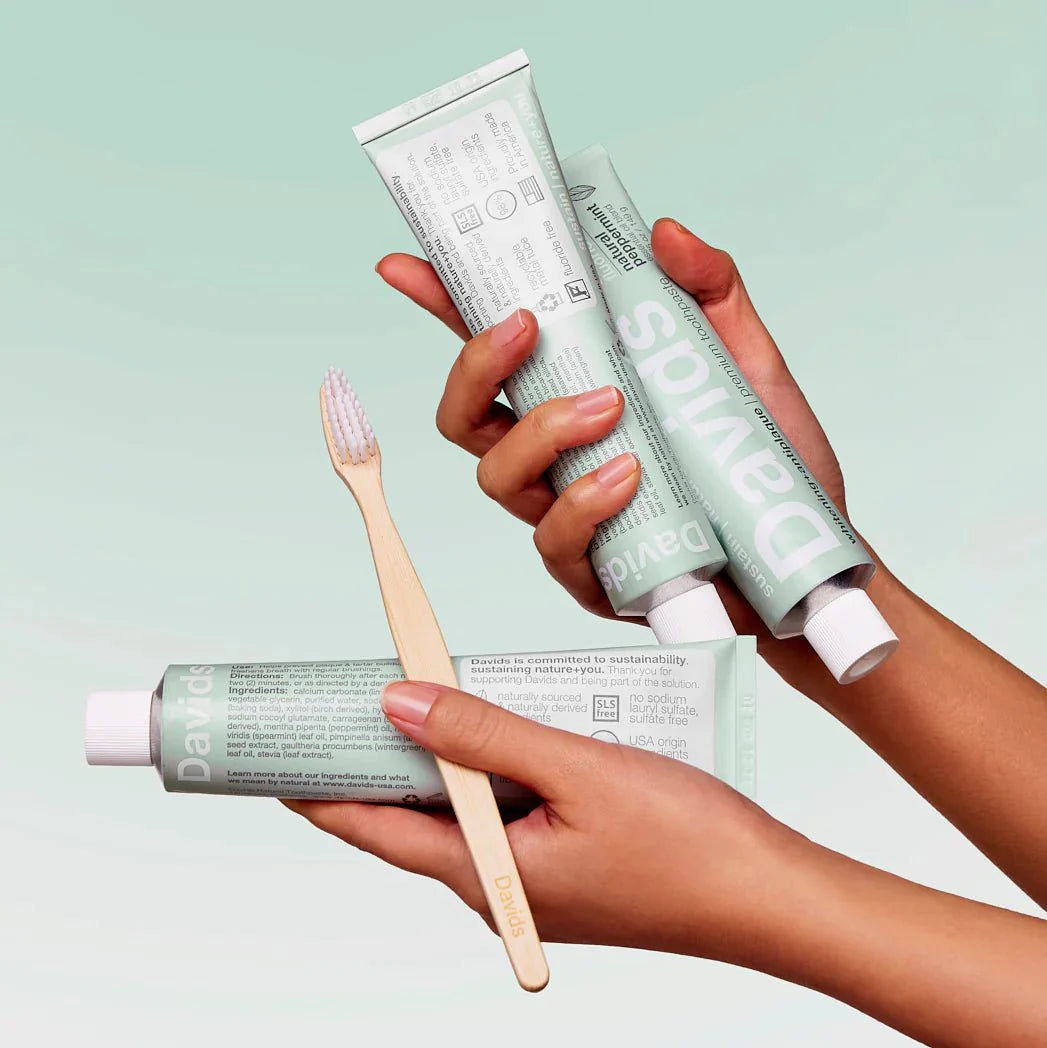hands-holding-davids-toothpaste-and-bamboo-toothbrush.jpg